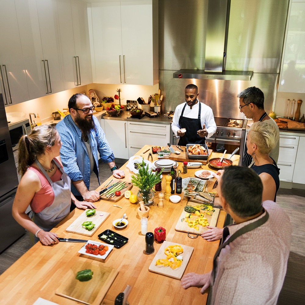 Colleagues cooking together in a culinary team challenge